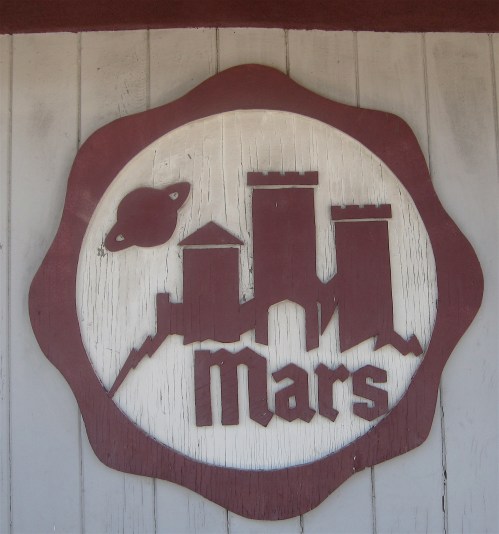 If I had to guess, this trippy sign was designed in the mid-'60s. I love the planet hovering over the castle, but isn't Saturn the one with the rings?