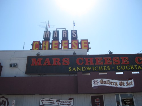 The sun shines over the Mars Cheese Castle sign, an I-94 landmark