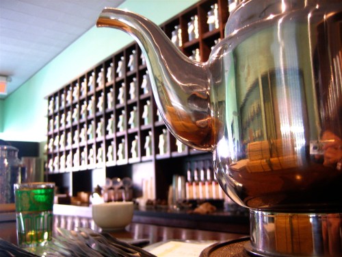 A wall of silver urns behind the counter